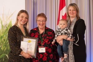 Olivia Lumley accepting the award on behalf of her father (left) with Ruth Hill and Merilee Hill